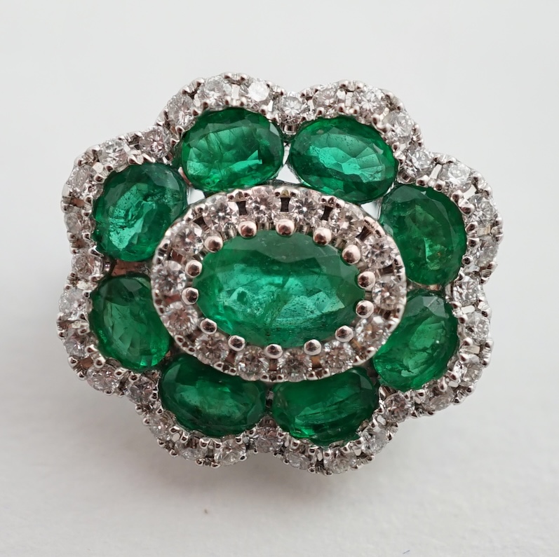 A mid to late 20th century white gold, emerald and diamond cluster set brooch